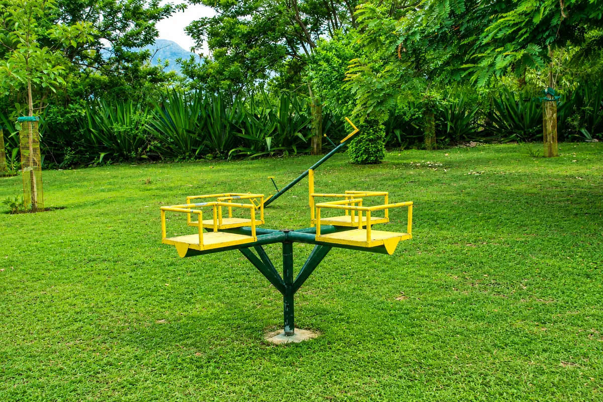 Play equipment on the open lawn at Aranyasun in Masinagudi