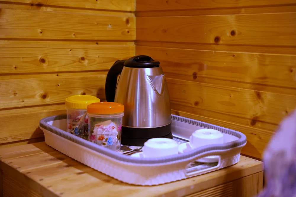 Kettle, cups and tea and coffee on a tray in a Deluxe Room at Labdhi Resorts