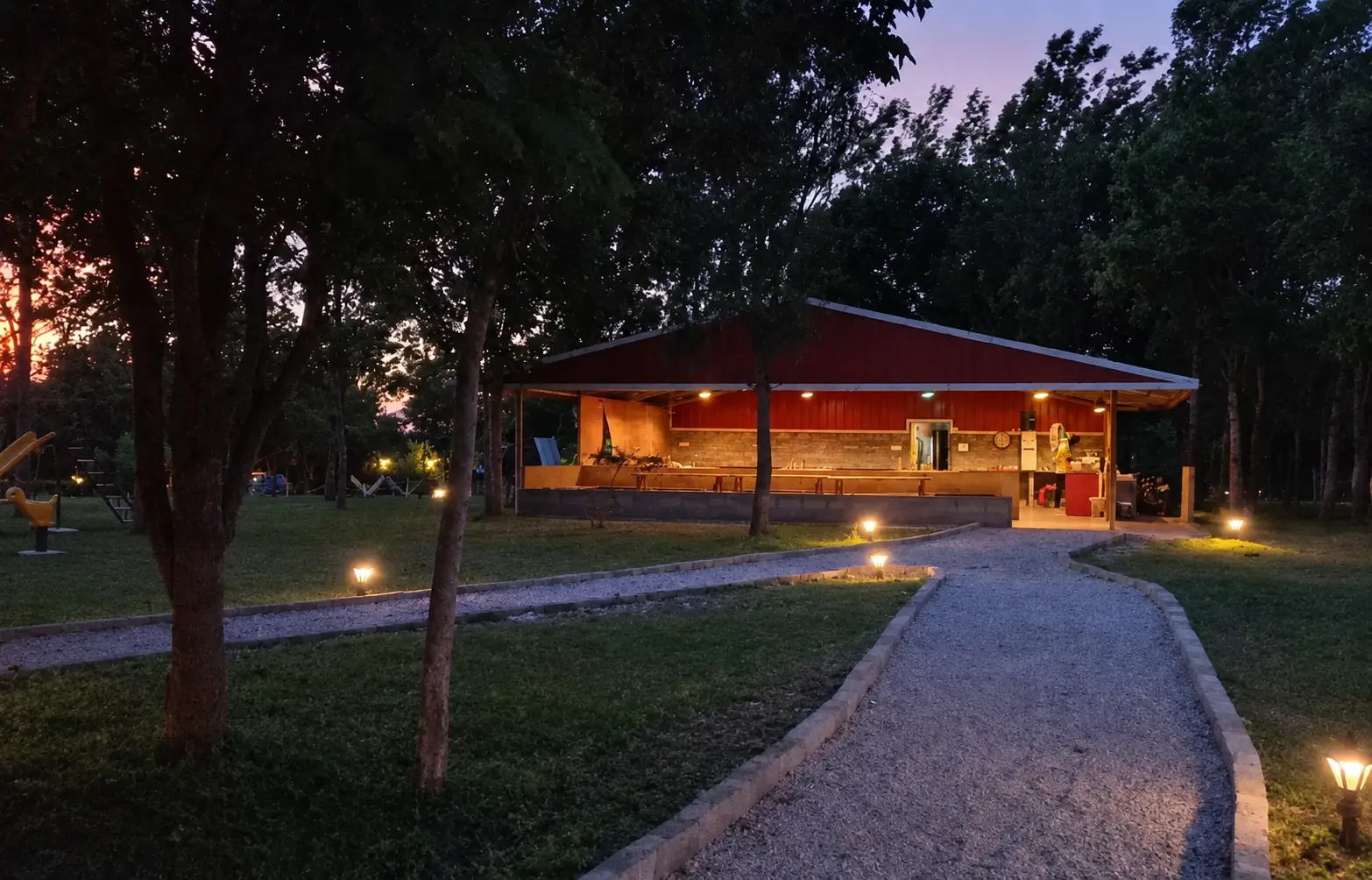 The lit path leading to the main building at Labdhi Resorts at dusk