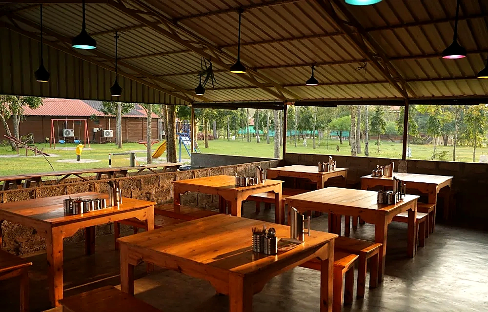 The restaurant at Labdhi Resorts with long timber tables