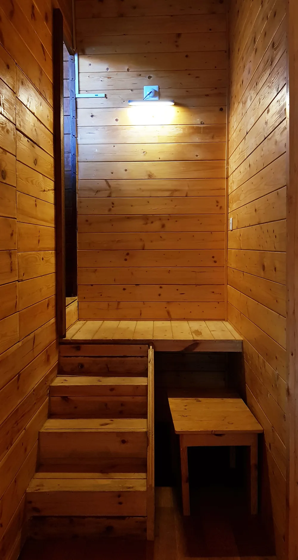 Timber stairs climbing to the loft level of the Superior King Room with Loft at Labdhi Resorts